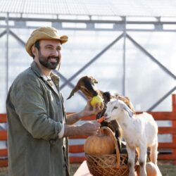 young-farmer-feeding-his-goats-vegetables-farm_optimized_200