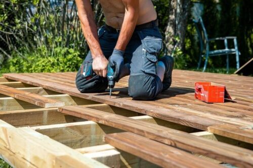 deck-construction-builder-hand-with-electric-screwdriver-installing-impregnated-wooden-boards_664057-14811 deck-construction-builder-hand-with-electric-screwdriver-installing-impregnated-wooden-boards_664057-14811