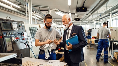 senior-quality-control-inspector-young-worker-cooperating-while-analyzing-manufactured-products-factory-plant senior-quality-control-inspector-young-worker-cooperating-while-analyzing-manufactured-products-factory-plant