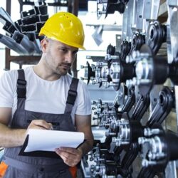 industrial-employee-wearing-uniform-yellow-hardhat-checking-production-factory