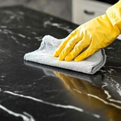 person-wearing-glove-is-cleaning-kitchen-counter_875765-4865