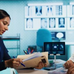 general-practitioner-consulting-patient-reviewing-x-ray-test-results (1)